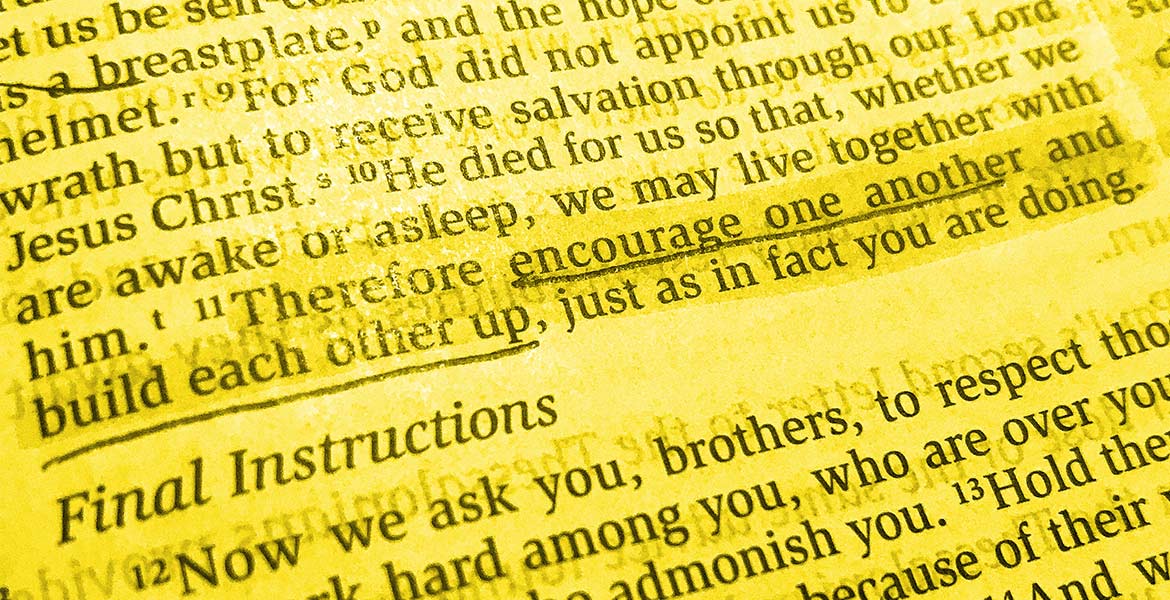 Picture of the Bible opened to 1 Thessalonians 5:11